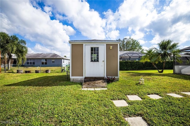 view of outbuilding with a yard