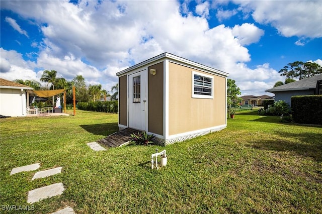 view of outdoor structure with a lawn