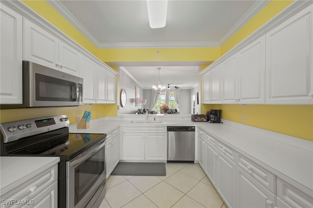 kitchen with sink, white cabinets, ornamental molding, and appliances with stainless steel finishes