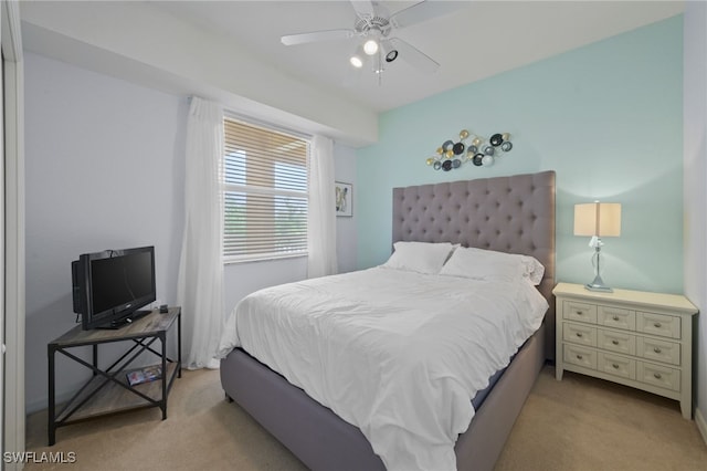 bedroom featuring light colored carpet and ceiling fan