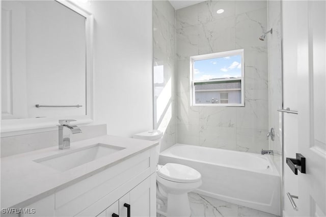 full bathroom with vanity, tiled shower / bath combo, and toilet