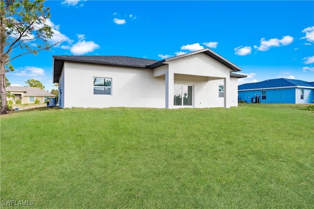 rear view of house with a lawn