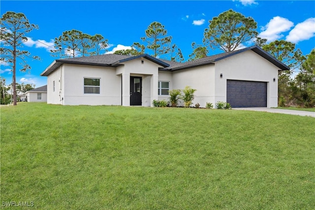 view of front of property featuring a garage and a front lawn