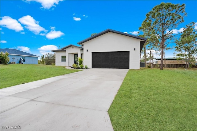 view of front of property featuring a front yard and a garage