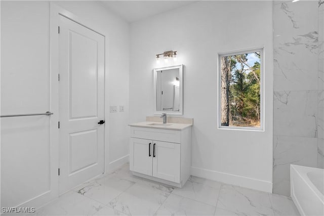 bathroom featuring a washtub and vanity