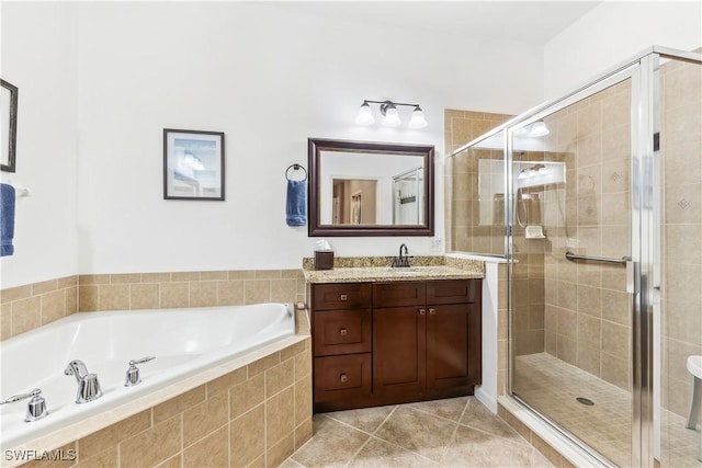 bathroom featuring tile patterned floors, independent shower and bath, and vanity