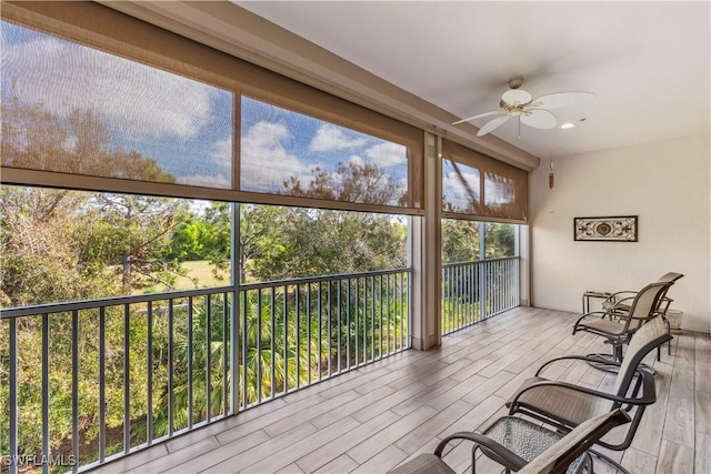 sunroom featuring ceiling fan