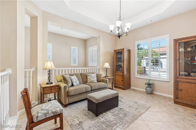 tiled living room with a raised ceiling and a notable chandelier