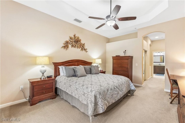 carpeted bedroom featuring connected bathroom and ceiling fan