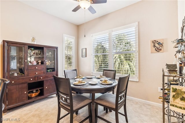 tiled dining room with ceiling fan