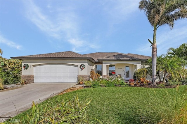 view of front of home featuring a garage and a front lawn