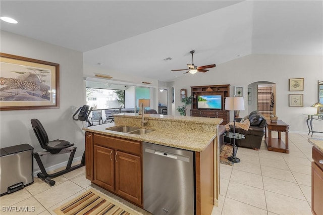 kitchen with sink, stainless steel dishwasher, lofted ceiling, a kitchen island with sink, and light tile patterned floors