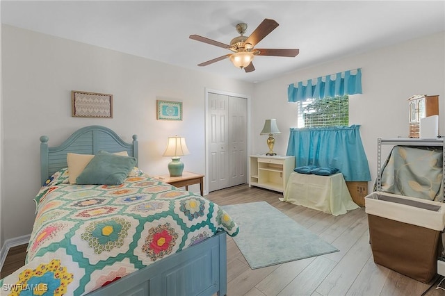 bedroom with a closet, light hardwood / wood-style floors, and ceiling fan