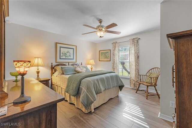 bedroom with ceiling fan and light hardwood / wood-style flooring