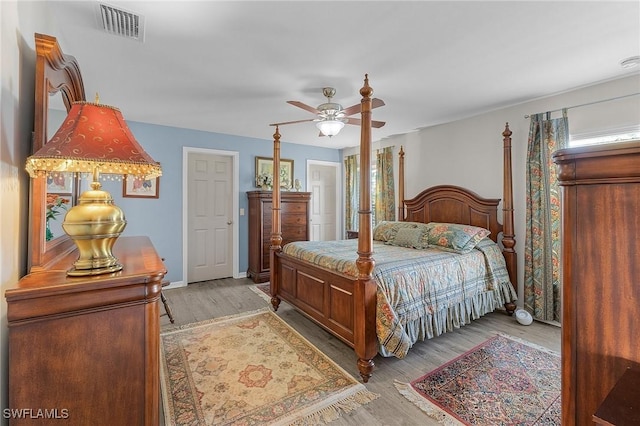 bedroom with ceiling fan and light hardwood / wood-style flooring