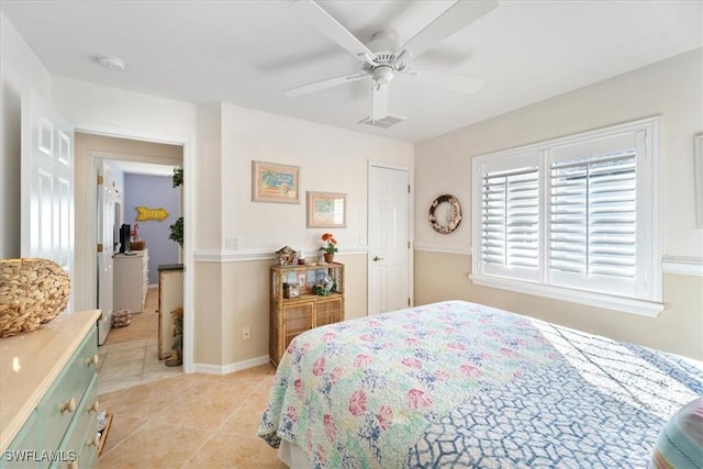 bedroom featuring light tile patterned floors and ceiling fan