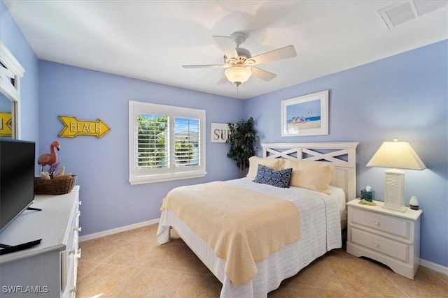 tiled bedroom featuring ceiling fan