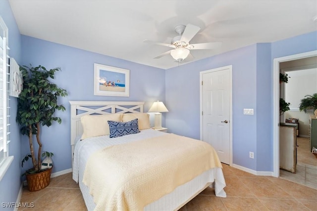 tiled bedroom featuring ceiling fan