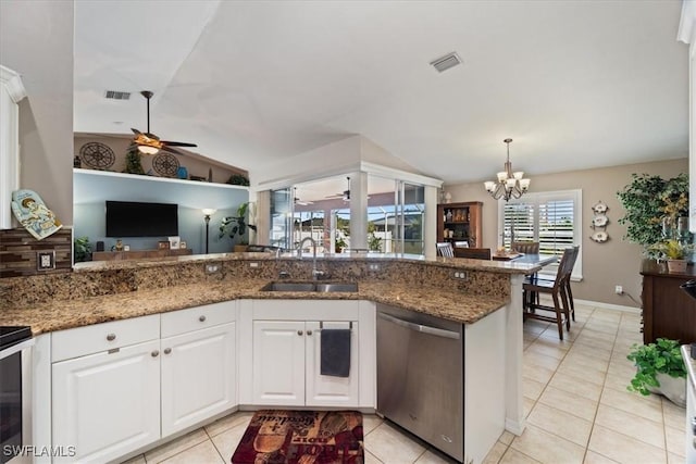 kitchen featuring white cabinets, sink, dark stone countertops, dishwasher, and lofted ceiling