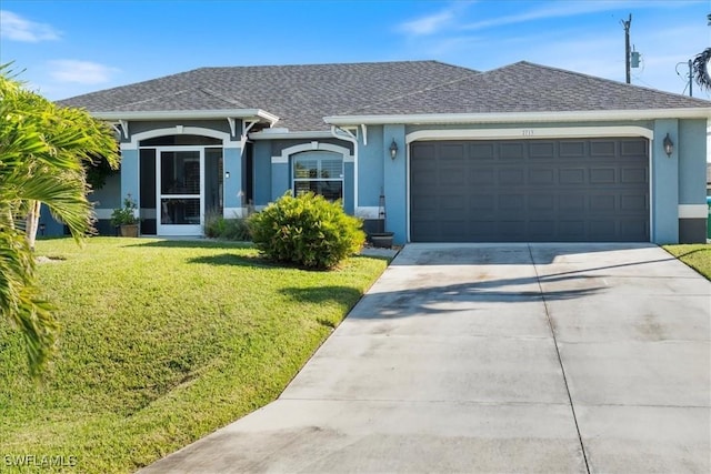 ranch-style home featuring a garage and a front lawn