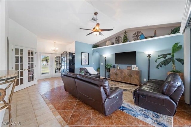 tiled living room with french doors, ceiling fan with notable chandelier, and vaulted ceiling