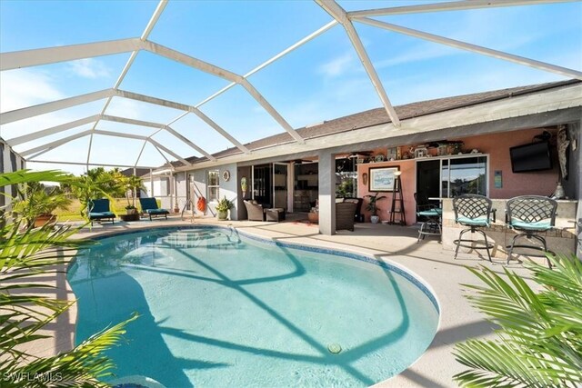 view of pool with glass enclosure, ceiling fan, a patio, and an outdoor living space