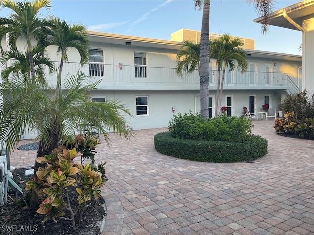 634 12th Ave S Unit 634, Naples, FL 34102 - back of house with stucco siding and a balcony
