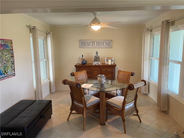 dining area with ceiling fan, light tile patterned flooring, and ornamental molding