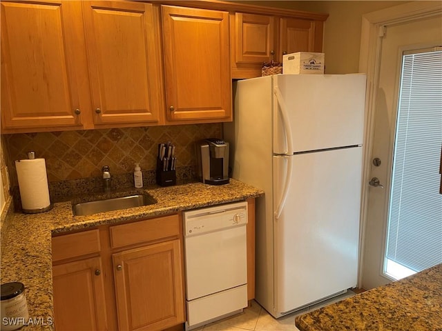 kitchen with white appliances, sink, decorative backsplash, stone countertops, and light tile patterned flooring