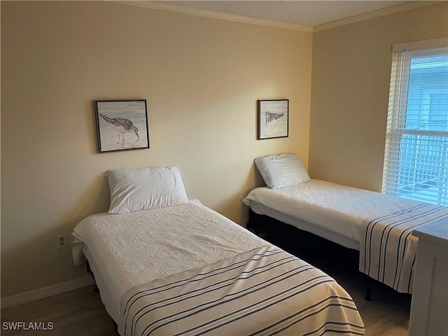 bedroom with wood-type flooring and crown molding