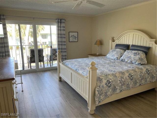 bedroom with access to exterior, ceiling fan, crown molding, wood-type flooring, and a textured ceiling