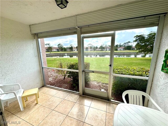 sunroom / solarium with a water view