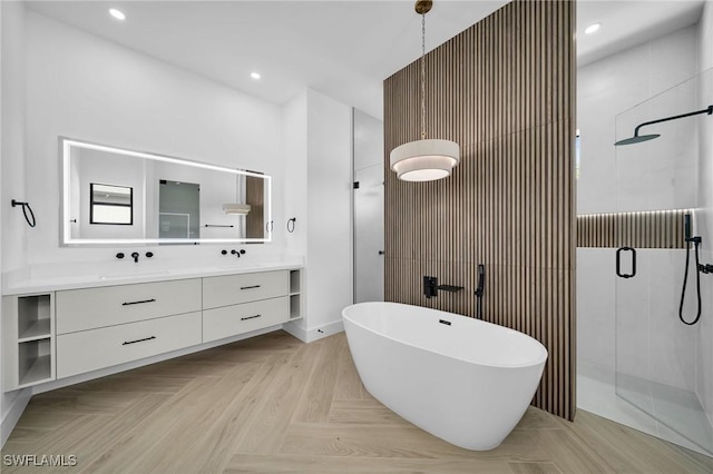 bathroom featuring parquet flooring, vanity, and independent shower and bath