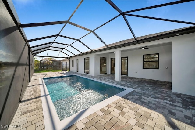 view of pool featuring a lanai, ceiling fan, and a patio