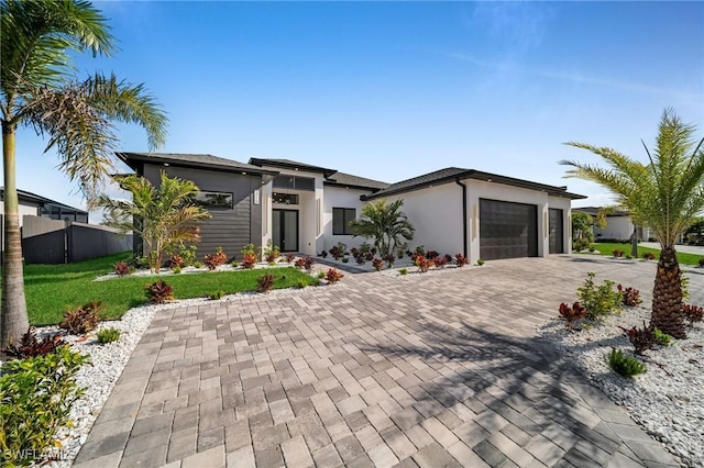 view of front of home featuring a front lawn and a garage