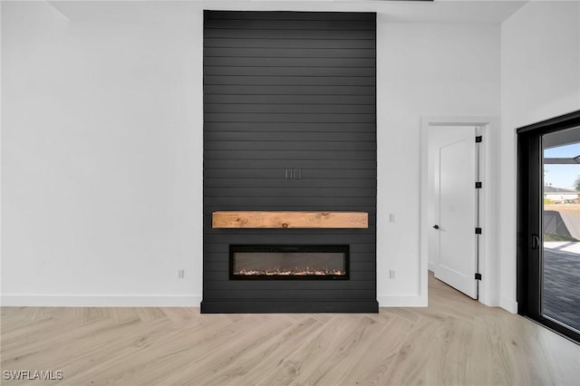 unfurnished living room featuring a fireplace and light hardwood / wood-style flooring