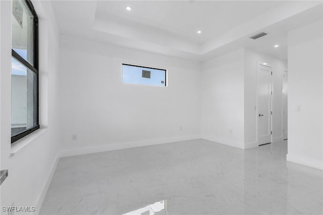 empty room featuring a raised ceiling