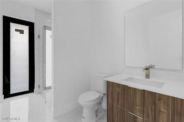 bathroom featuring tile patterned flooring, vanity, and toilet