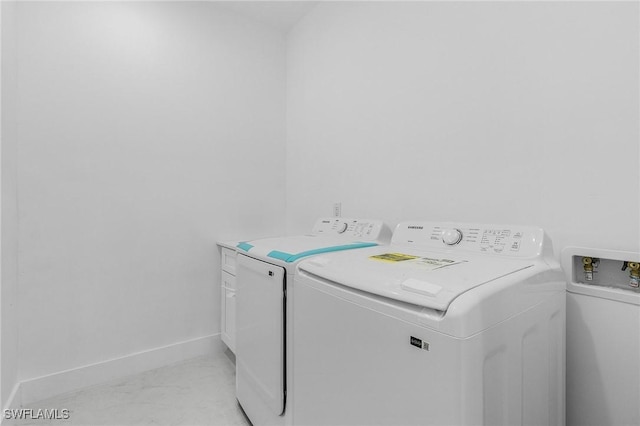 laundry area featuring cabinets and washing machine and dryer