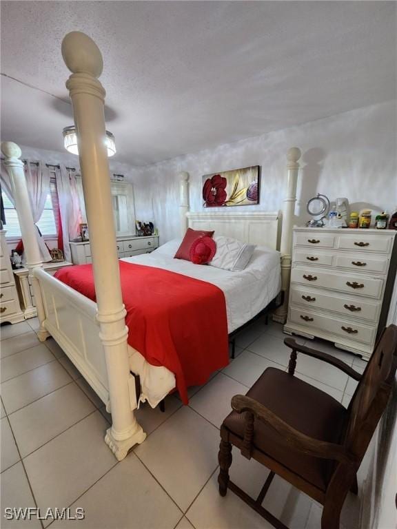 bedroom with light tile patterned floors and a textured ceiling