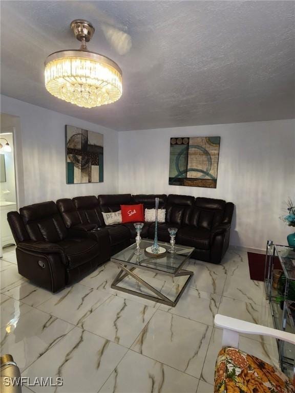 living room featuring a notable chandelier and a textured ceiling