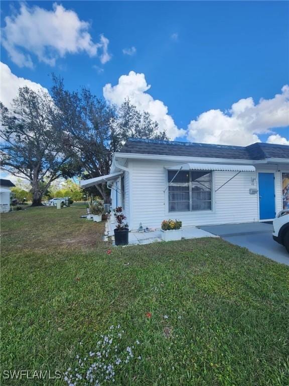 view of side of home with a lawn