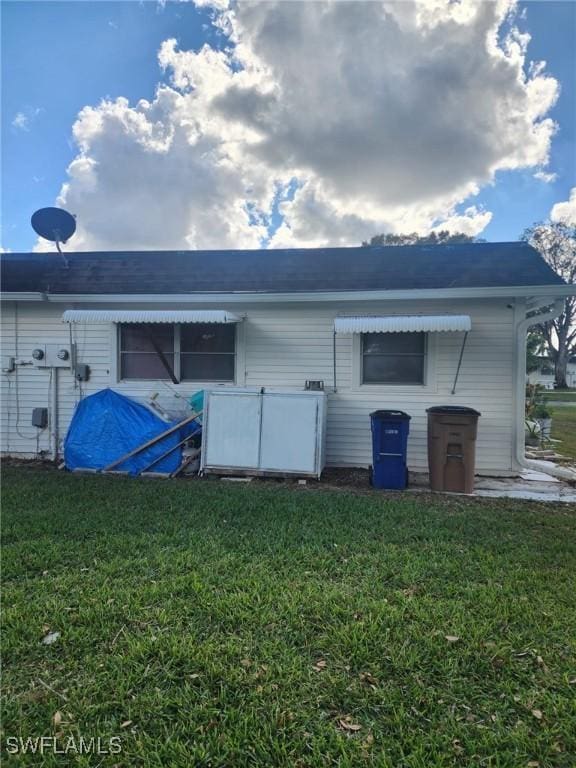 rear view of property featuring a yard