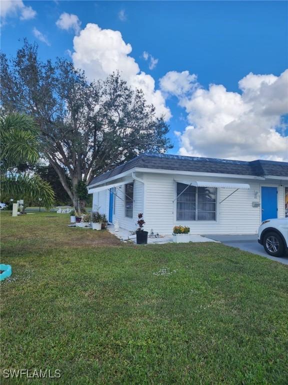 view of side of home with a lawn