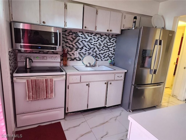 kitchen with decorative backsplash, sink, and appliances with stainless steel finishes