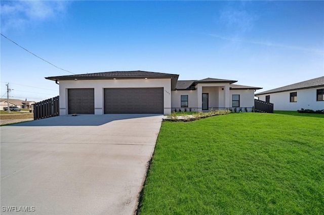 view of front of property featuring a garage and a front lawn