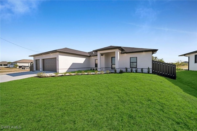 prairie-style home with a front yard and a garage