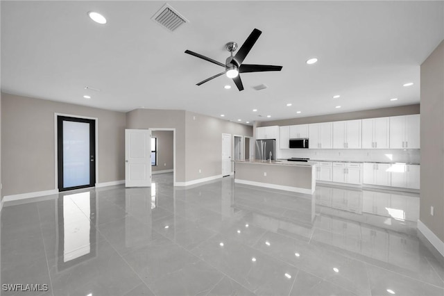 unfurnished living room featuring ceiling fan