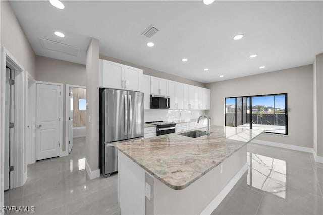 kitchen featuring a center island with sink, white cabinetry, sink, and appliances with stainless steel finishes