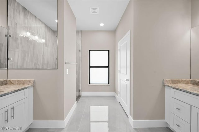 bathroom featuring tile patterned flooring, vanity, and a shower with shower door